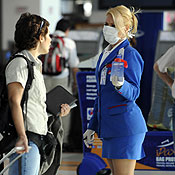 A sales rep wears a face mask at an airport 