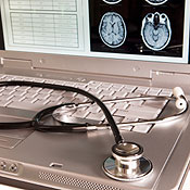 A stethoscope resting on a laptop 