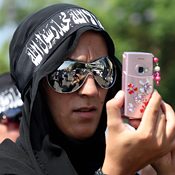 A Lebanese woman takes pictures with her cell 