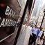 Pedestrians pass a Bank of America