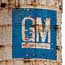 Paint peels from a shuttered GM assembly plant