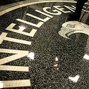 A man stands on the CIA seal 