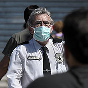 A security officer wears a mask 