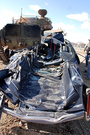 Photo A tank crushes a car at Fort Snelling Cars will be crushed on both 