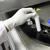 Chemical worker pulls out test tube 