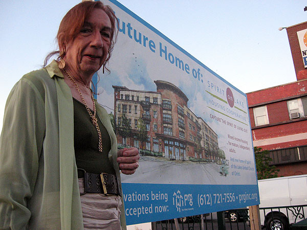 Barbara Satin, a transgendered activist, stands in front of the parking lot that she hopes will one day be replaced by the first gay-friendly senior home in the region.