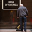 A man cleans up in front of a Bank of America