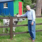 Ronnie Lamb, chairman of the local parish council, pets one of his donkeys. He opposes the Pinewood Studios project.