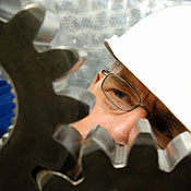An engineer examines industrial gear mechanics 