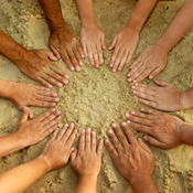 Hands together on the sand 