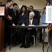 Florida Gov. Charlie Crist signs an insurance bill 