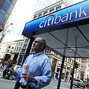A pedestrian walks by a Citibank branch office 