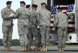An Army carry team carries a transfer case