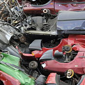 Wrecked cars are piled up on a scrapyard 