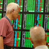 Investors check montors at a brokerage in Taipei 