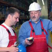 Older employee works with younger employee 