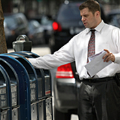 A man drops letters into a mailbox 