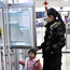 Chinese woman and daughter check out fridge