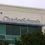 A Charles Schwab sign hangs on a building's side