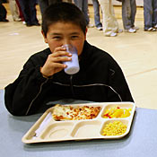 A student eats lunch at an elementary school. 