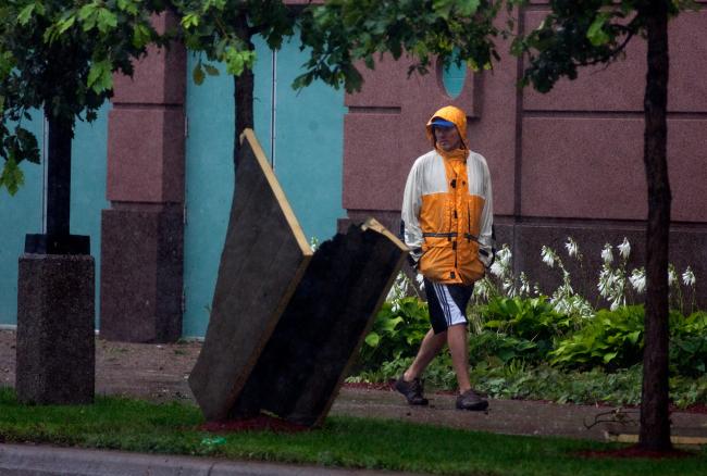 A passerby examines a piece of debris near the Convention Center.
