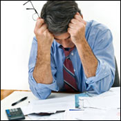 Man looks at mounting debts. 