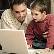 A daddy with his son at a computer 