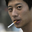 A young man smokes cigarettes in Beijing
