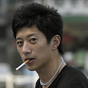 A young man smokes cigarettes in Beijing 