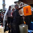 Palestinians fill jerrycans with water