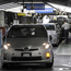 Toyota workers check Prius cars on assembly line