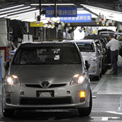 Toyota workers check Prius cars on assembly line 