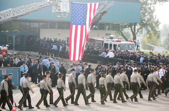 Hundreds of service officers file into Aldrich Arena for the funeral of Richard Crittenden in Maplewood Friday, Sept. 11, 2009.