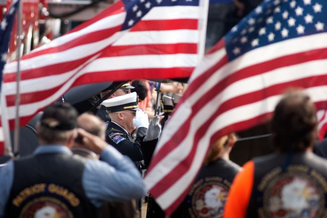 The remains of Richard Crittenden are saluted moments before they are taken into Aldrich Arena for Crittenden's funeral service in Maplewood Friday, September 11, 2009.