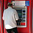 Bank customer uses ATM machine.