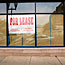 For Lease sign hangs in vacant store in Chicago