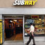 A man passes a Subway shop in New York City.