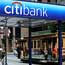 A cable car passes a Citibank branch