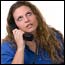 A frustrated woman listening to voicemail