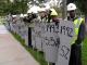 Protesters stage a mock funeral