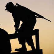 Silhouette of a U.S. soldier boarding truck 