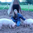 Emma pets two of her pigs