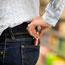 Shoplifter puts lipstick in back pocket.