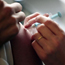 A nurse vaccinates a medical worker.