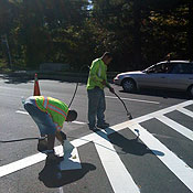 A crew paints a road in Washington D.C. 