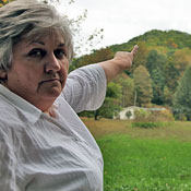 Lorelei Scarbro points to Coal River Mountain, where she would like to see wind turbines, but which could be mined for coal.
