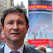 Mark Fulton, climate change strategist for Deutsche Bank. The company's carbon clock near Penn Station in New York City can be seen behind him.