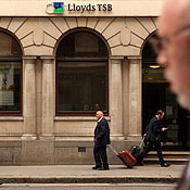 People walk past a Lloyds Bank 