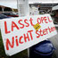 A sign reads 'Don't let Opel die'