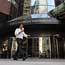 A man walks past the offices of AIG